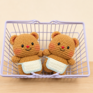 Two finished Apron Bear crochet keychain dolls in a lavender basket