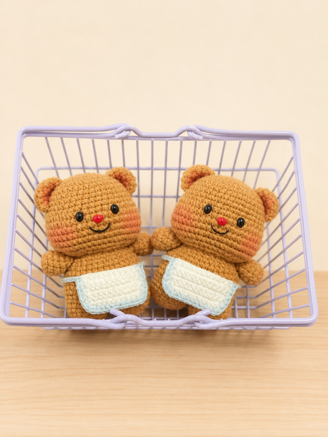 Two finished Apron Bear crochet keychain dolls in a lavender basket