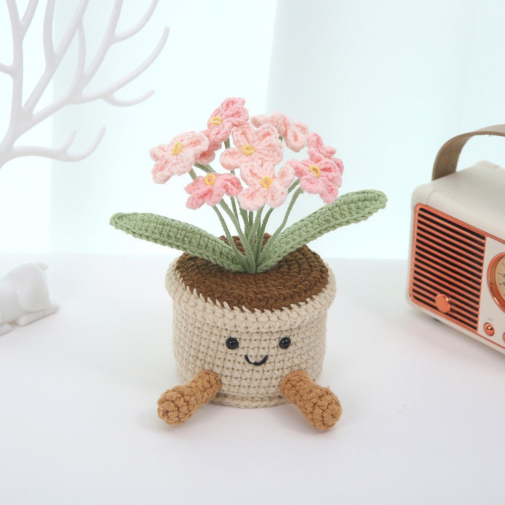 Crocheted flower pot with a smiling face